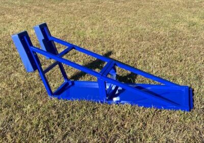 Blue metal ramp structure on grass,
